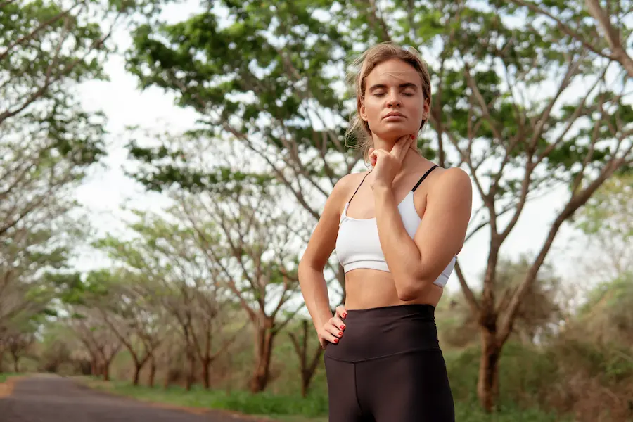 runner performing breathing techniques before going out for a run