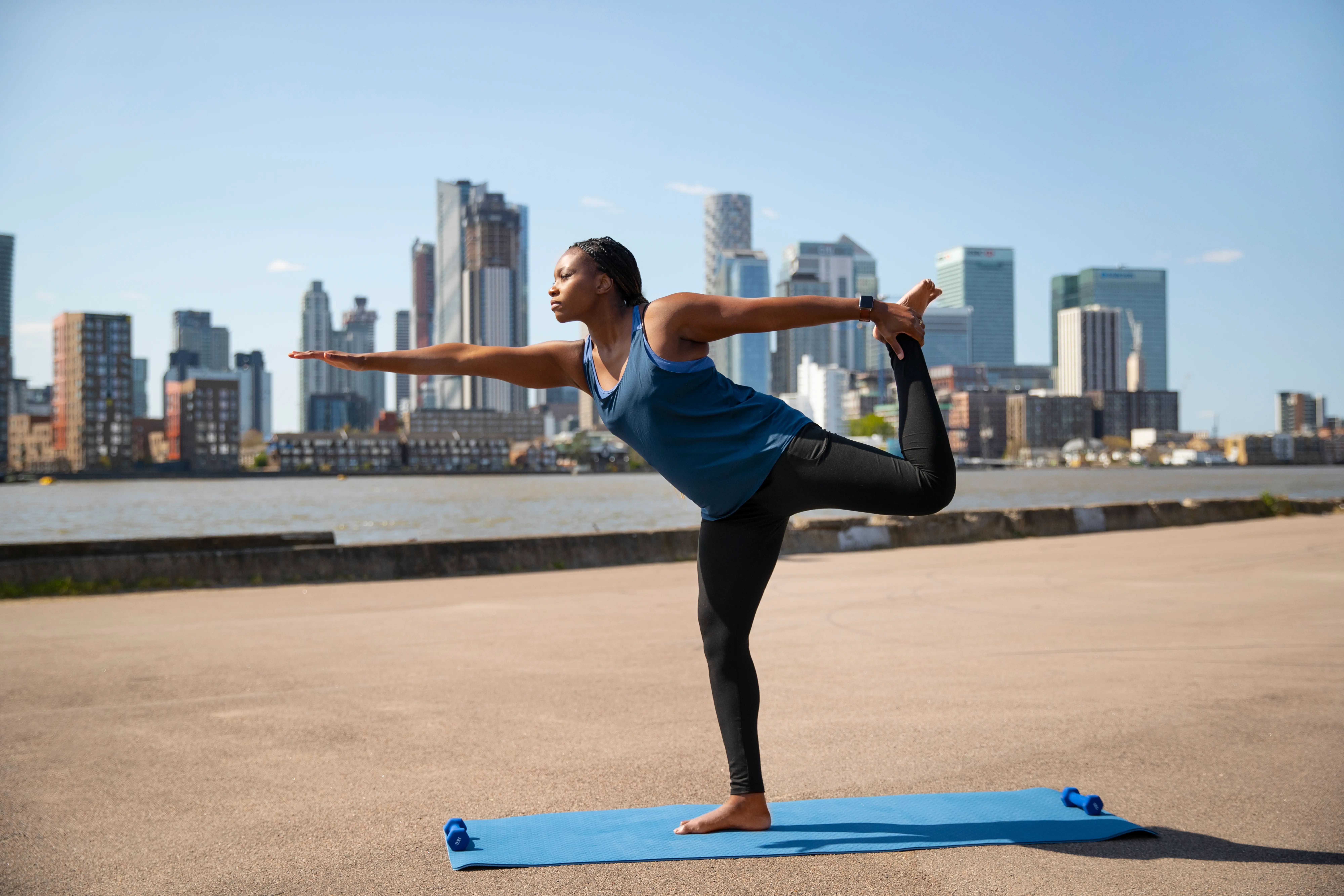 Athlete practicing leg stretches for recovery after running.